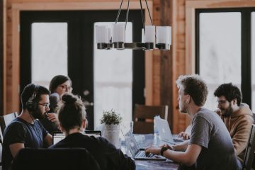 Groupe de jeunes autour d'une table avec leurs ordinateurs portables